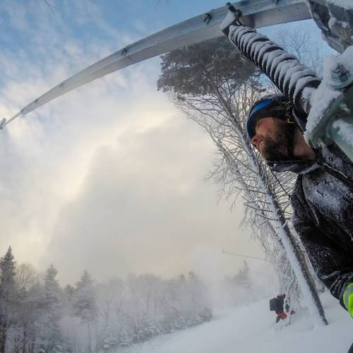 Skier and snowboarder on Angel Street at Loon Mountain