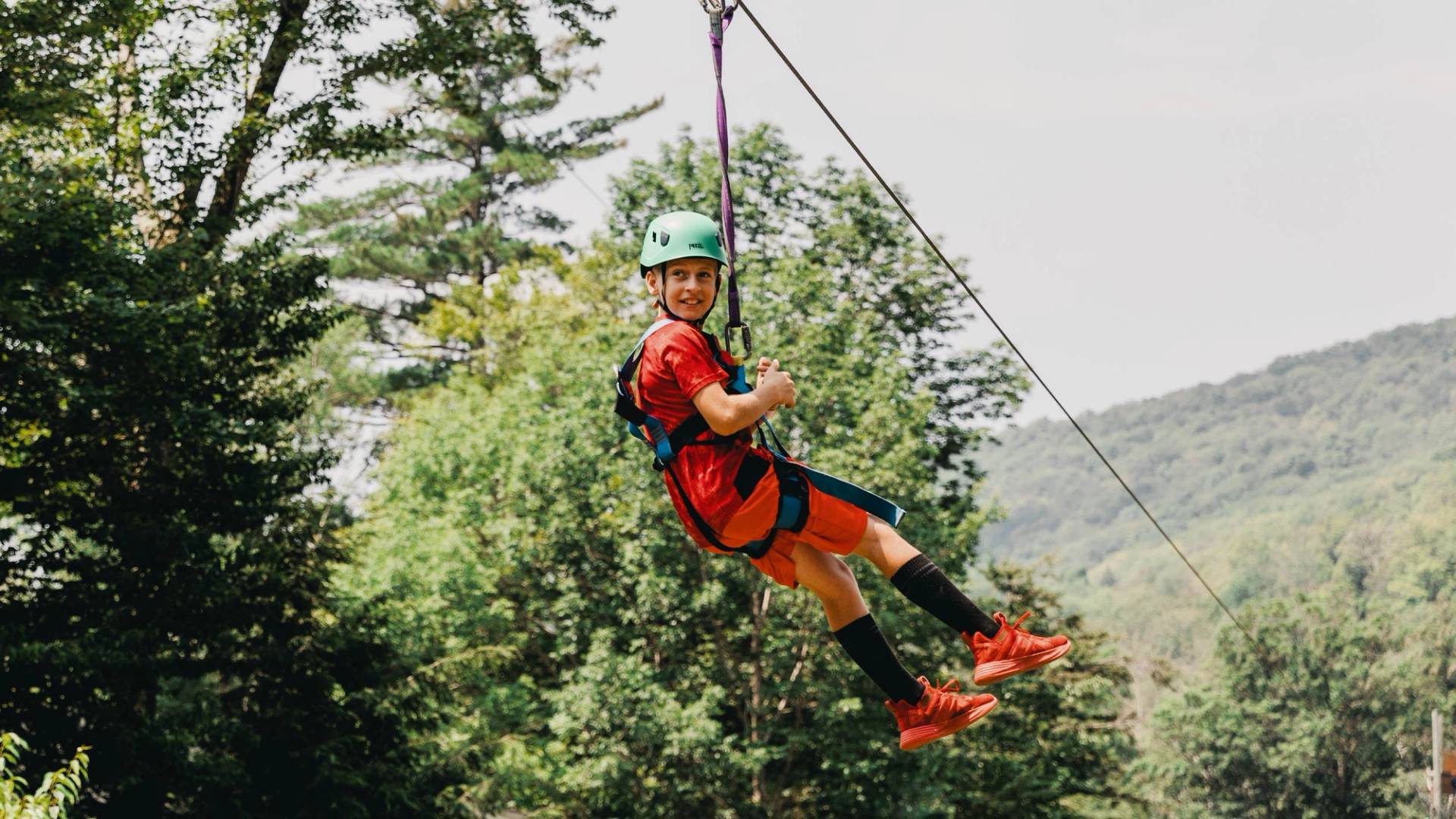 camper riding the zipline