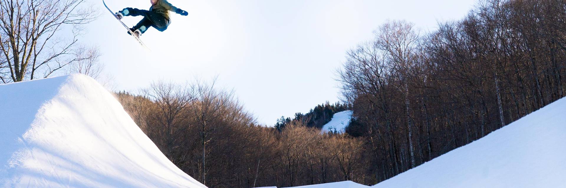 Snowboarder riding the halfpipe