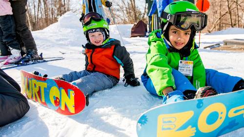 two young snowboarders in a kids snowboard lesson at Loon Mountain