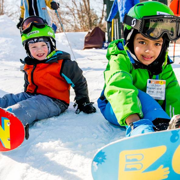 Two young boys taking a kids snowboard lesson at Loon Mountain