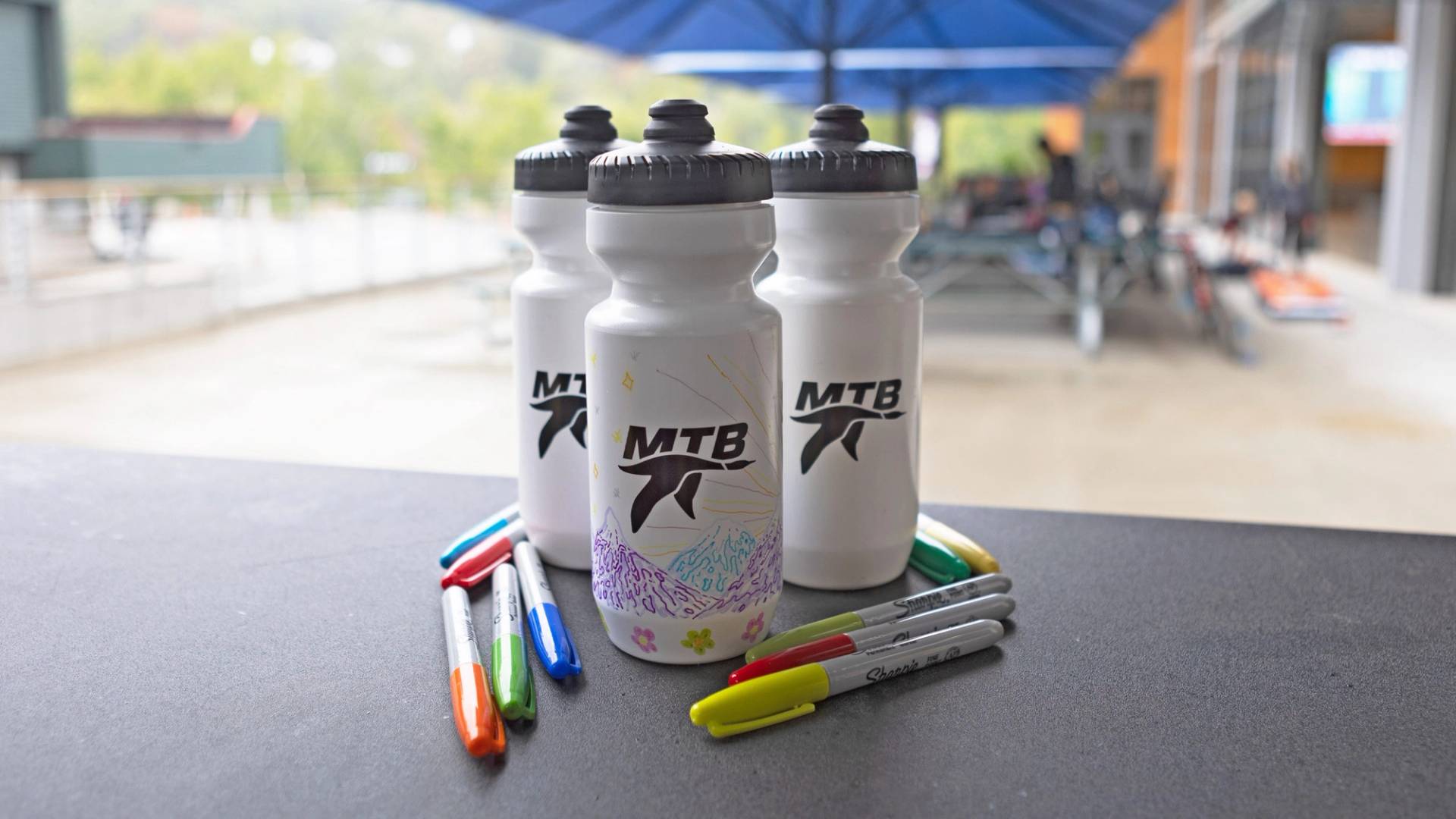 water bottles with markers next to them