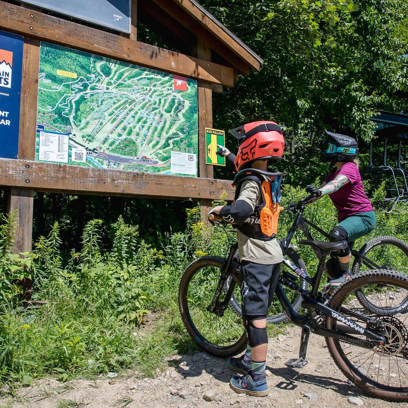 two riders looking at trail map