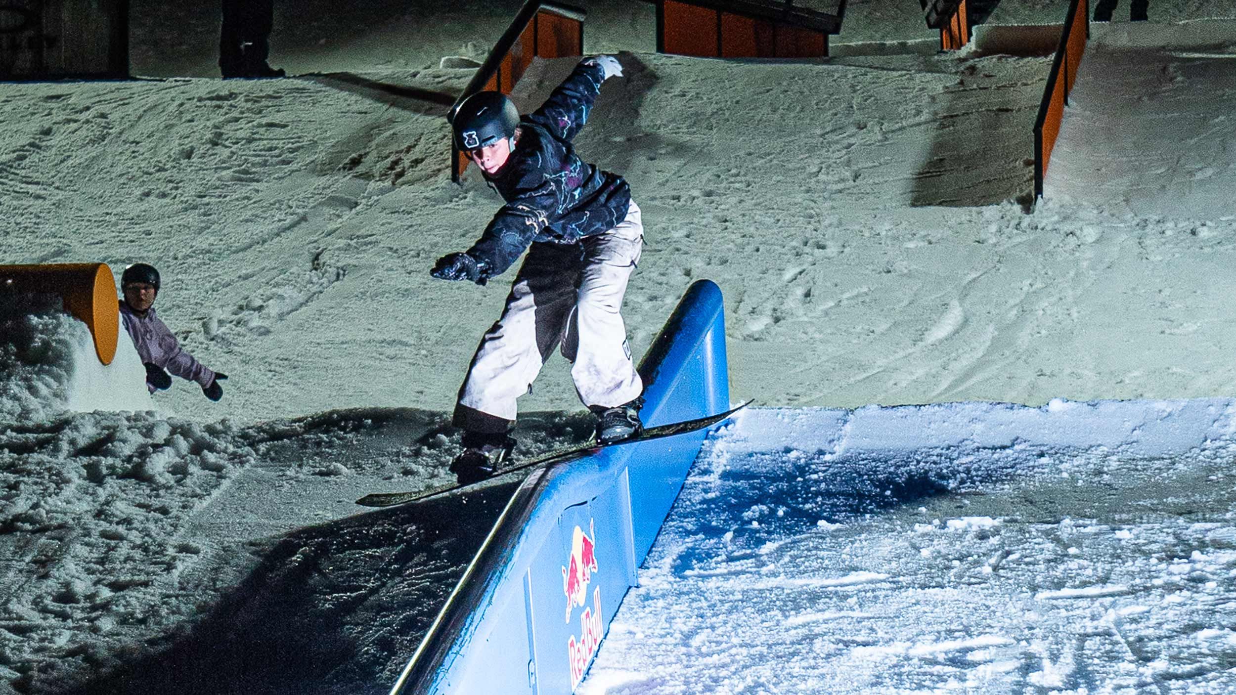 Snowboarder riding a rail at Cease and Desist