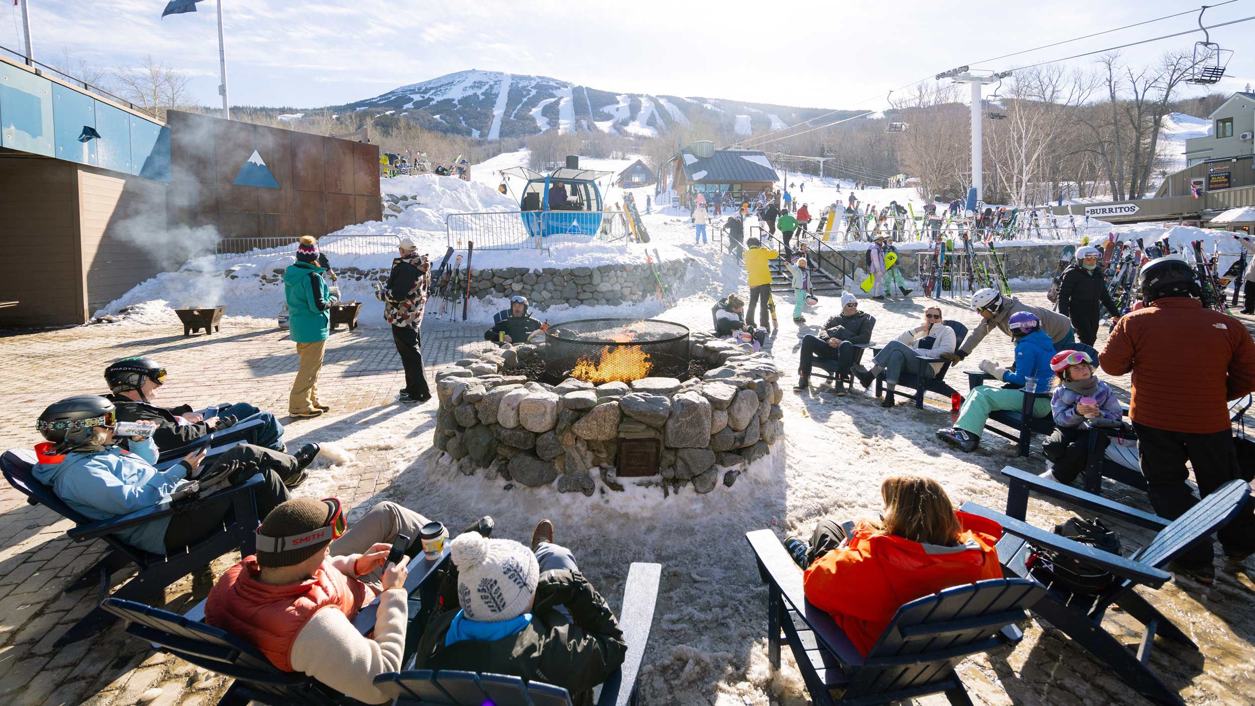 Skiers sitting in chairs at Sugarloaf
