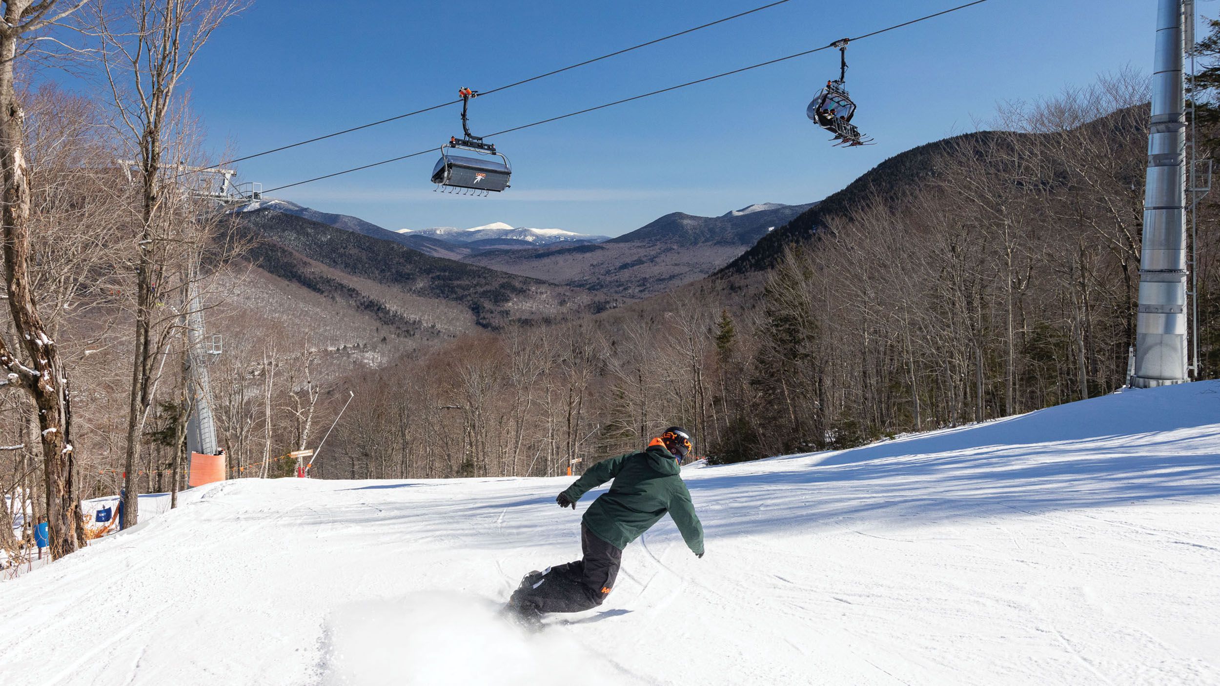 snowboarder riding under Kanc 8 chairift at Loon Mountain