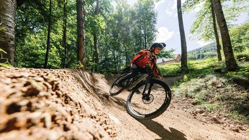 Teenager cornering a berm in Loon Bike Park