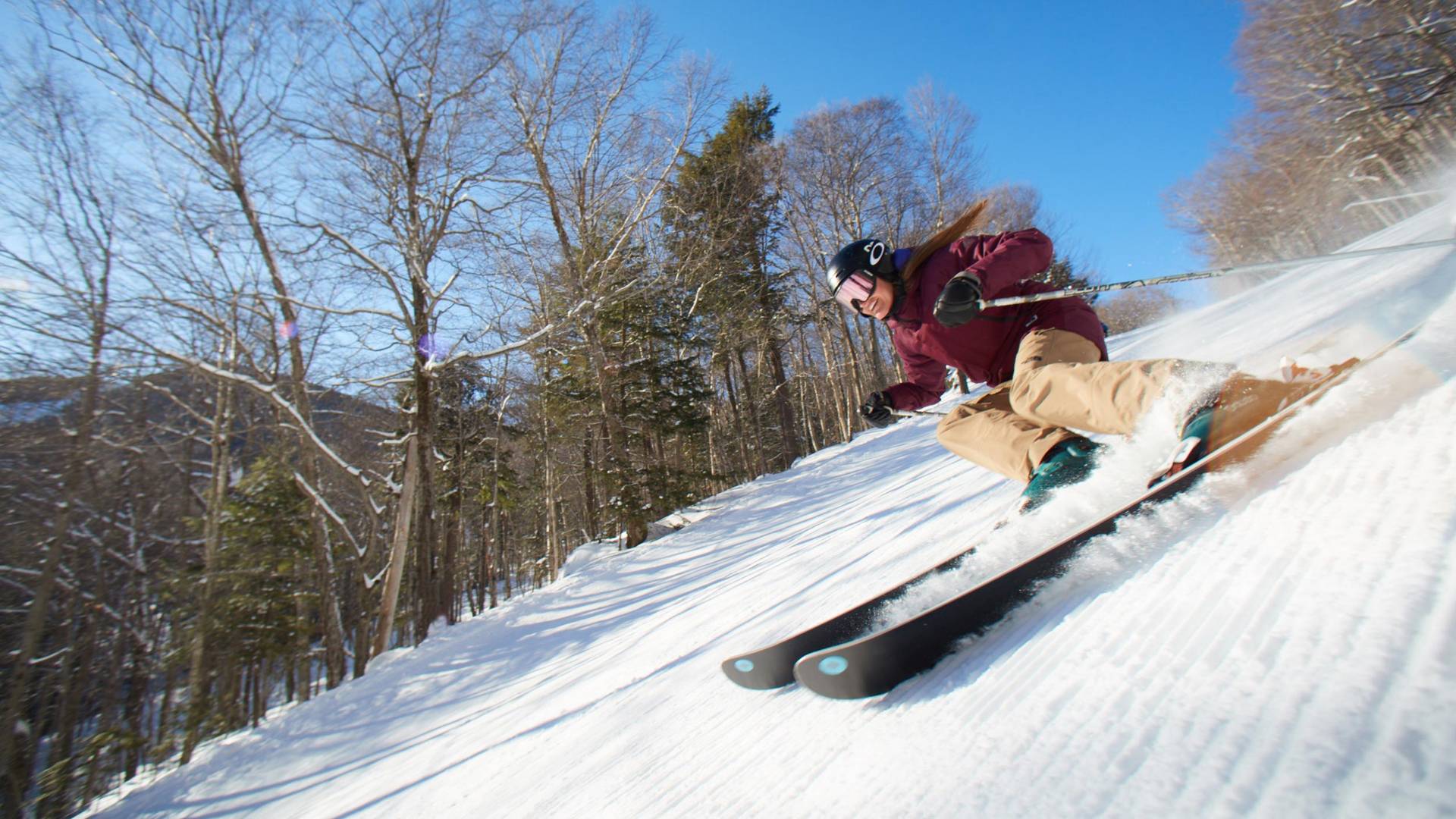 Woman skiing corduroy conditions at Loon Mountain