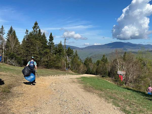 two team members hiking for garbage