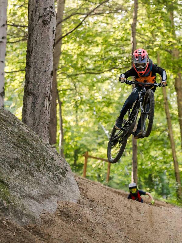 Rider riding off a rock in the Loon Bike Park