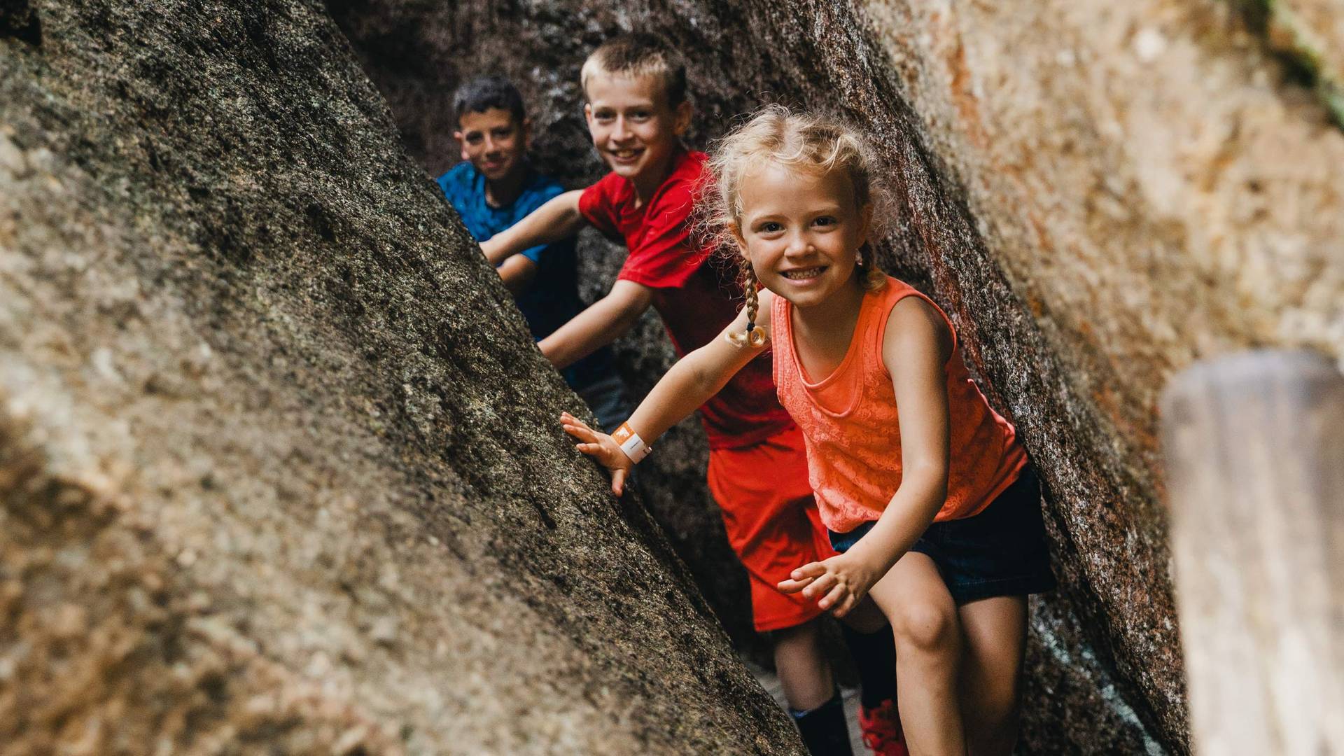kids walking through glacial caves