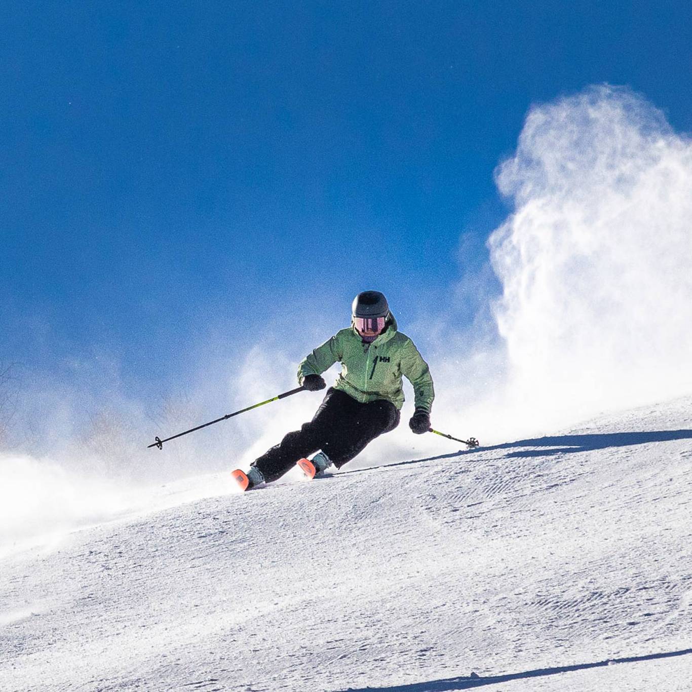 Skier in a green jacket
