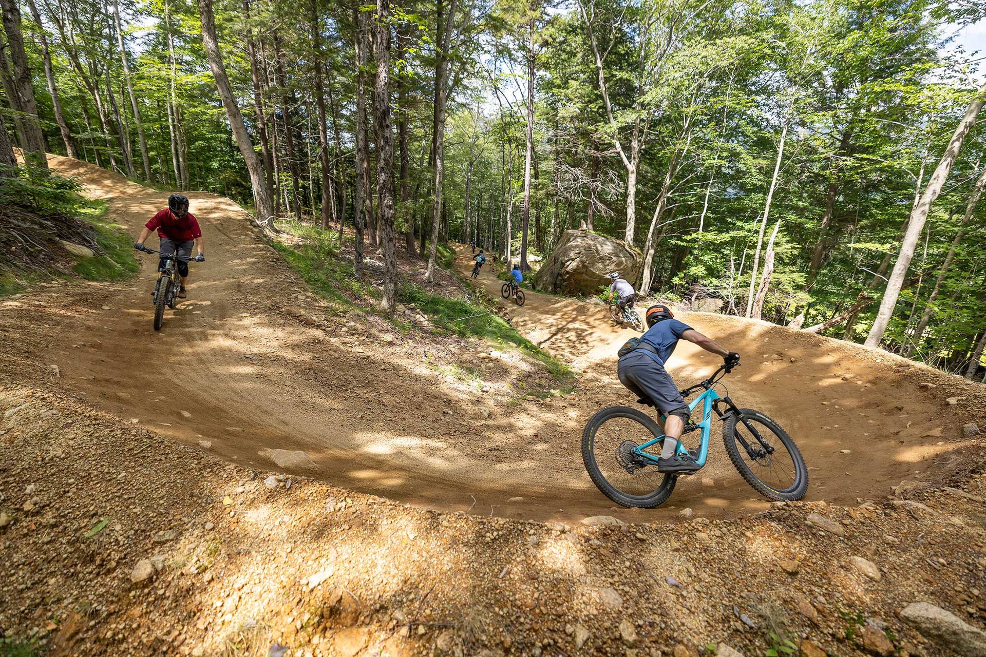 two bikers riding a berm