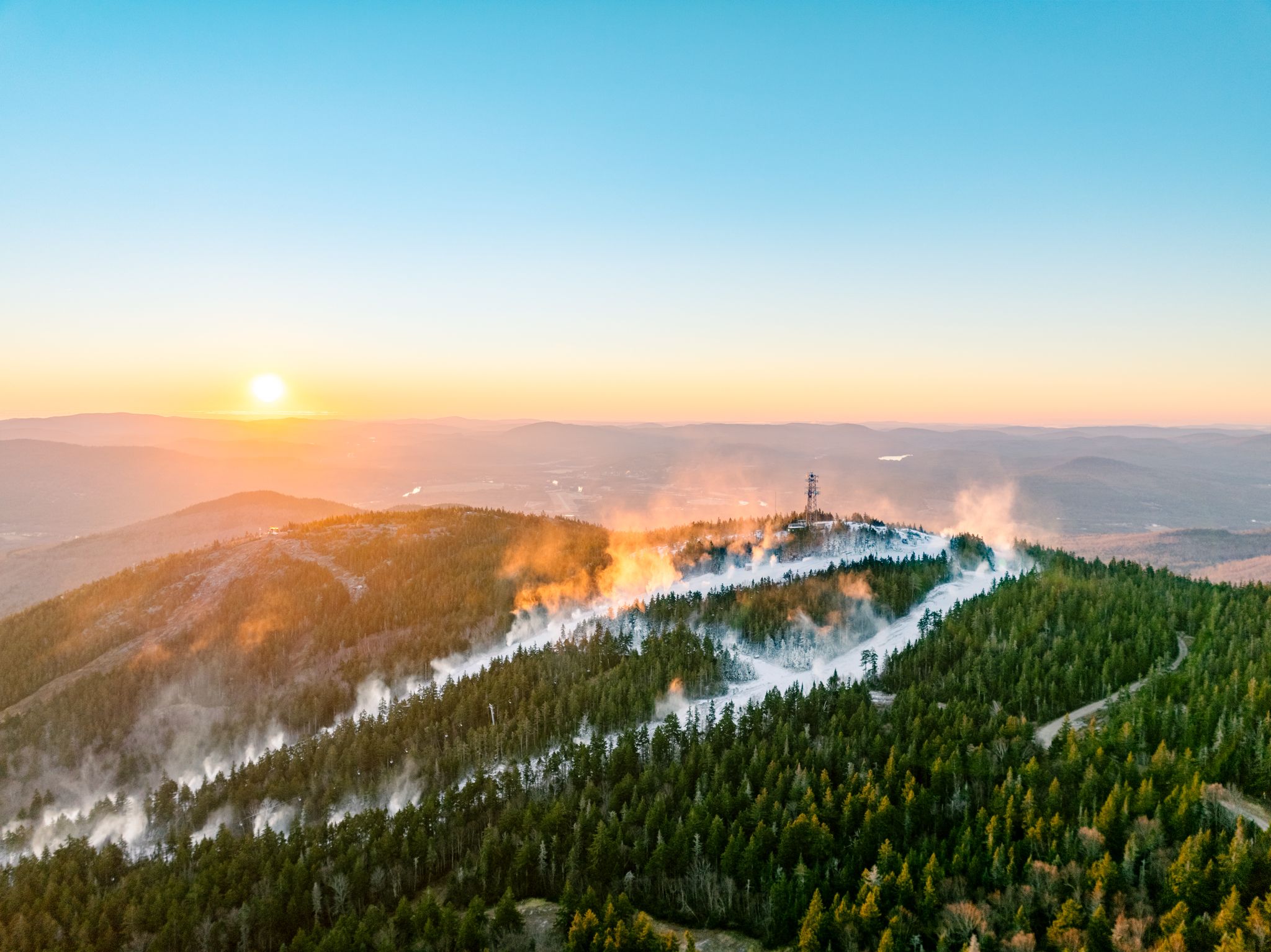 Snowmaking at Sunday River as the sun rises.