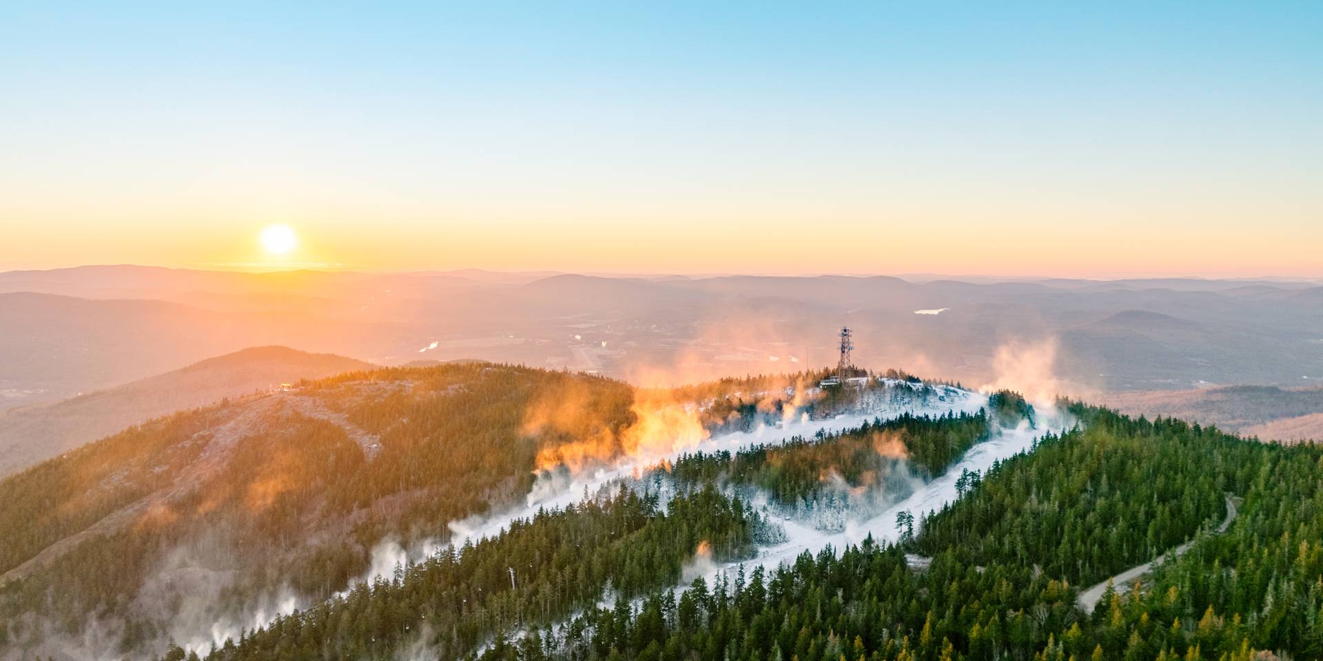 Snowmaking at Sunday River as the sun rises.