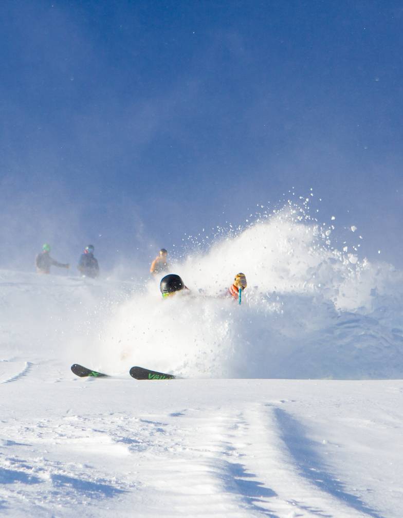 A person skiing in powder.
