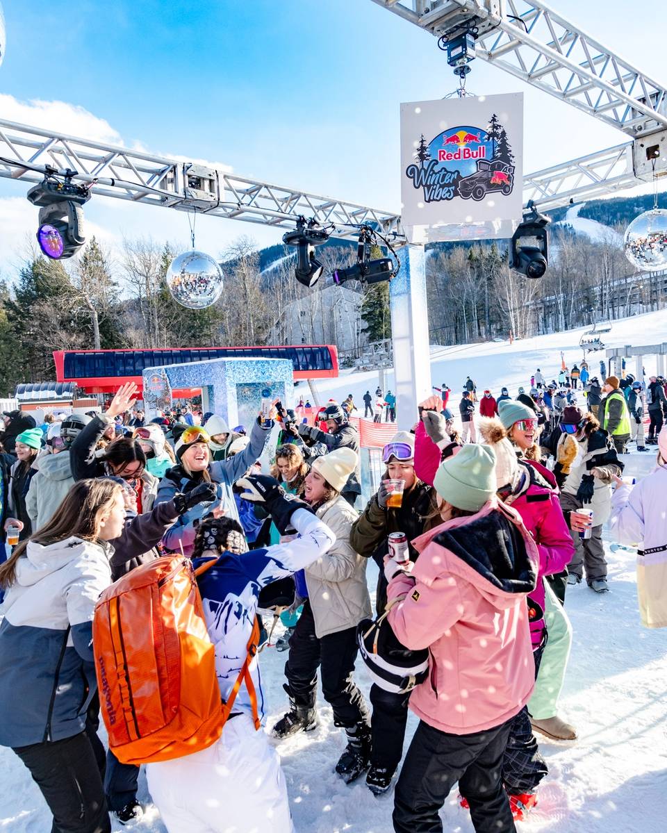 A slopeside party with people in ski gear.