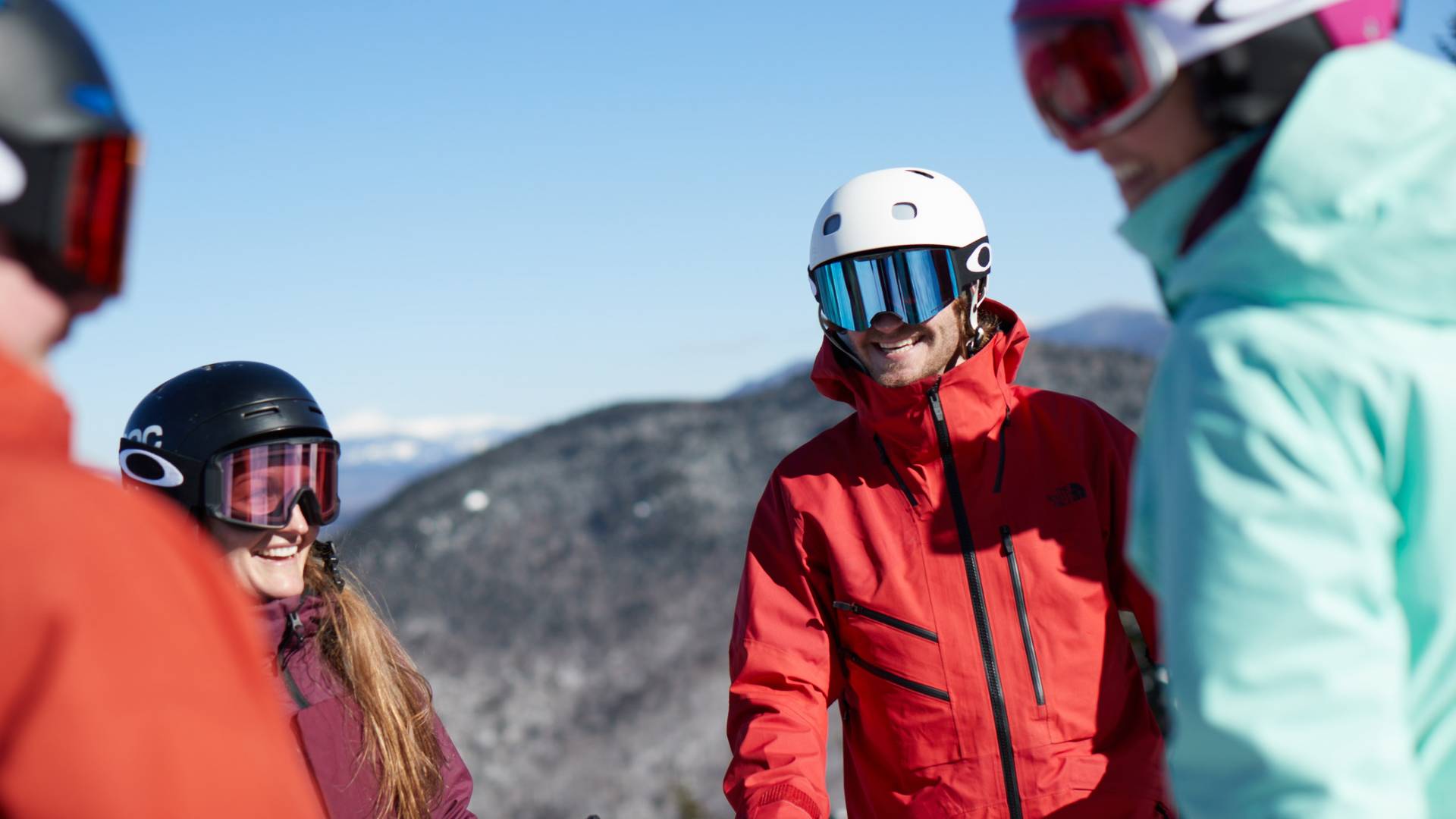 Group of smiling skiers and snowboarders at Loon.