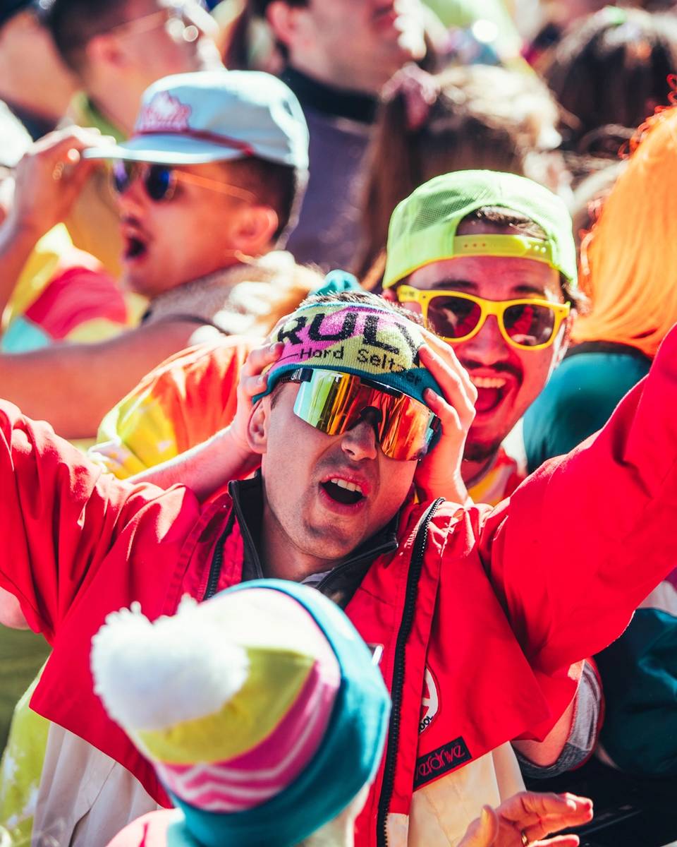 Two young-adults wearing bright neon at a party.