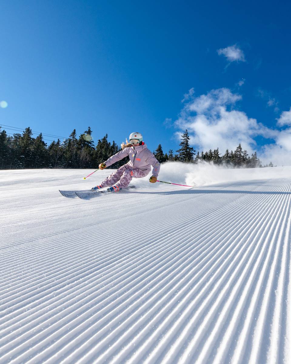 Women skiing powder in New England