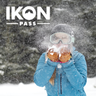 A skier blowing snow with the Ikon Pass logo