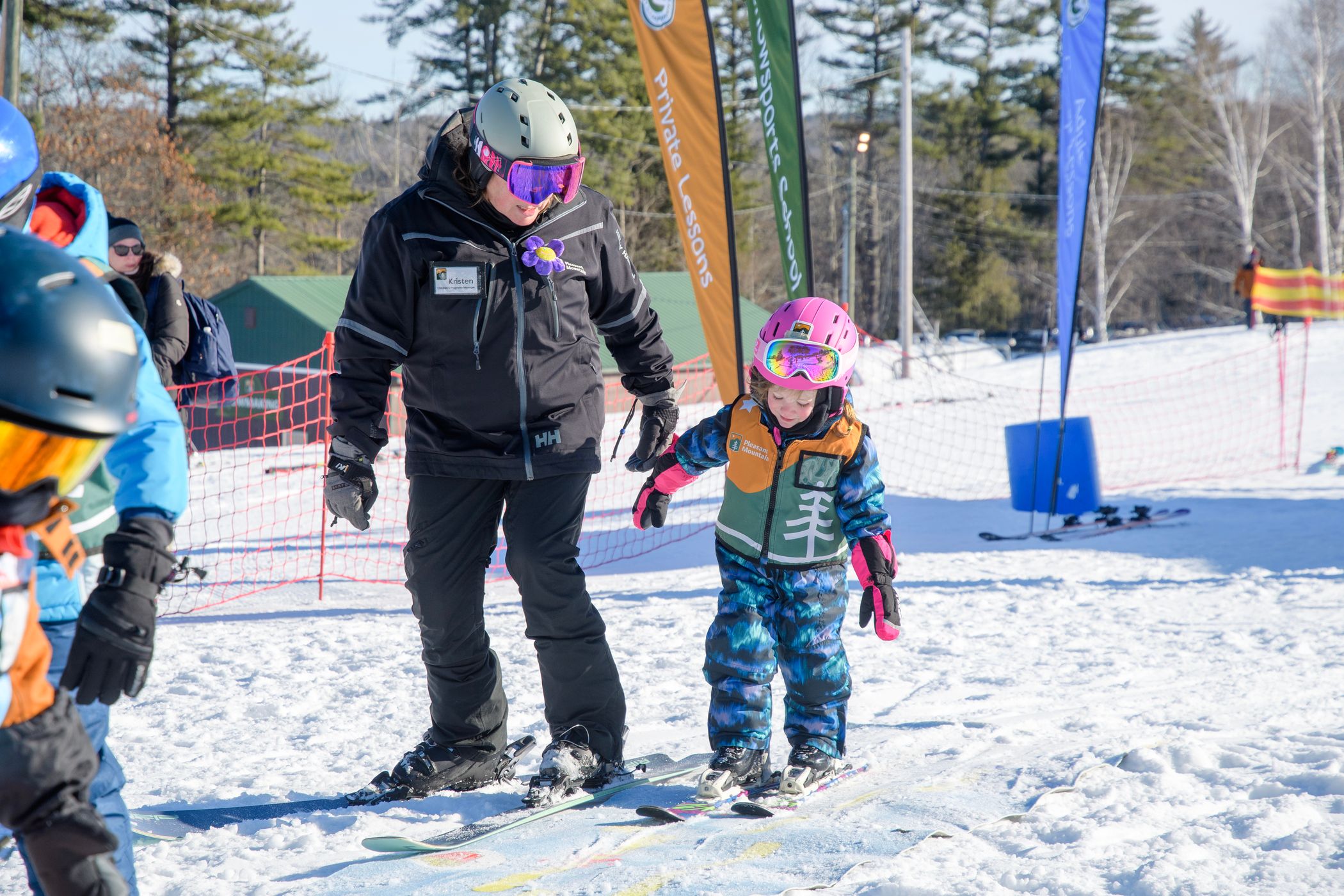 Little girl gets help from her instructor