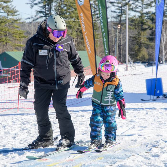 Little girl gets help from her instructor