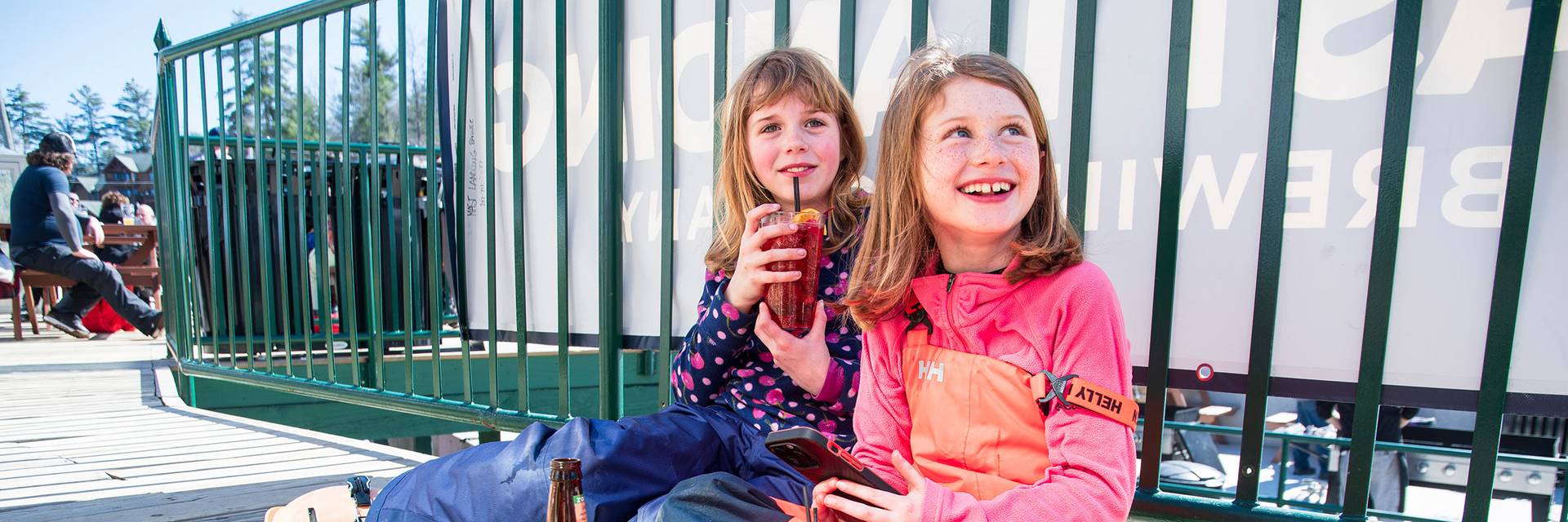 Two sweet little girls drink soda