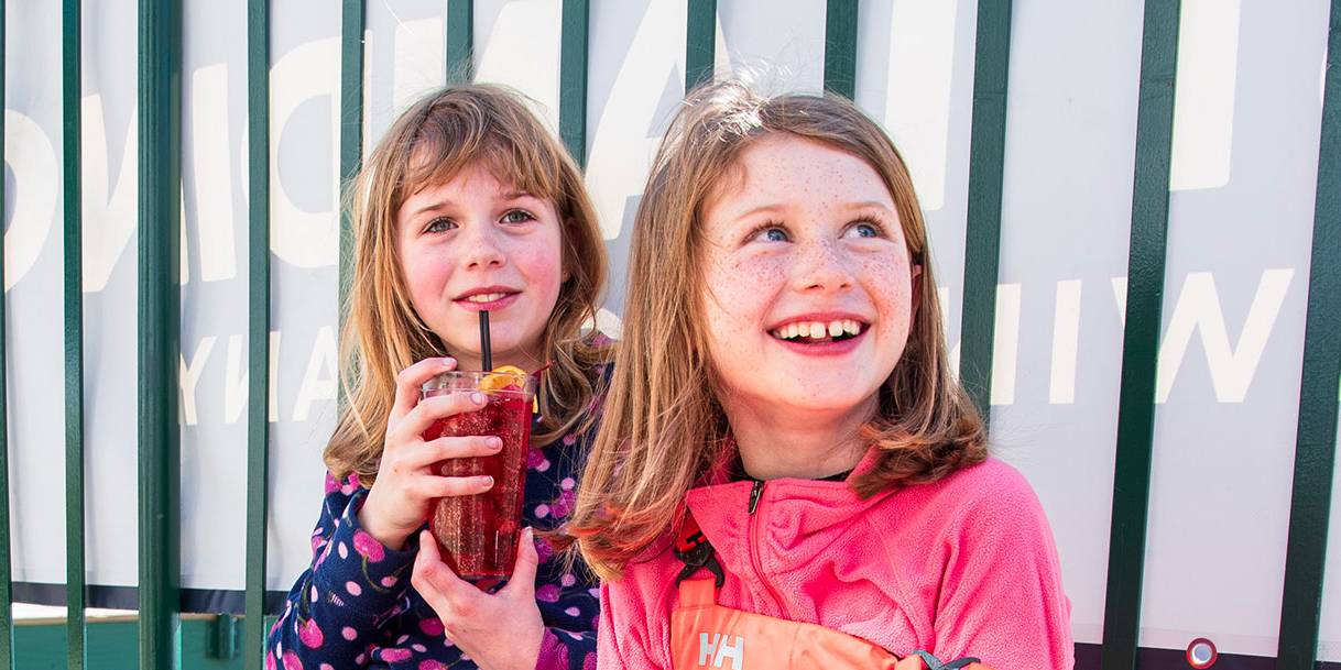 Little girls enjoy a soda on Blizzards Deck