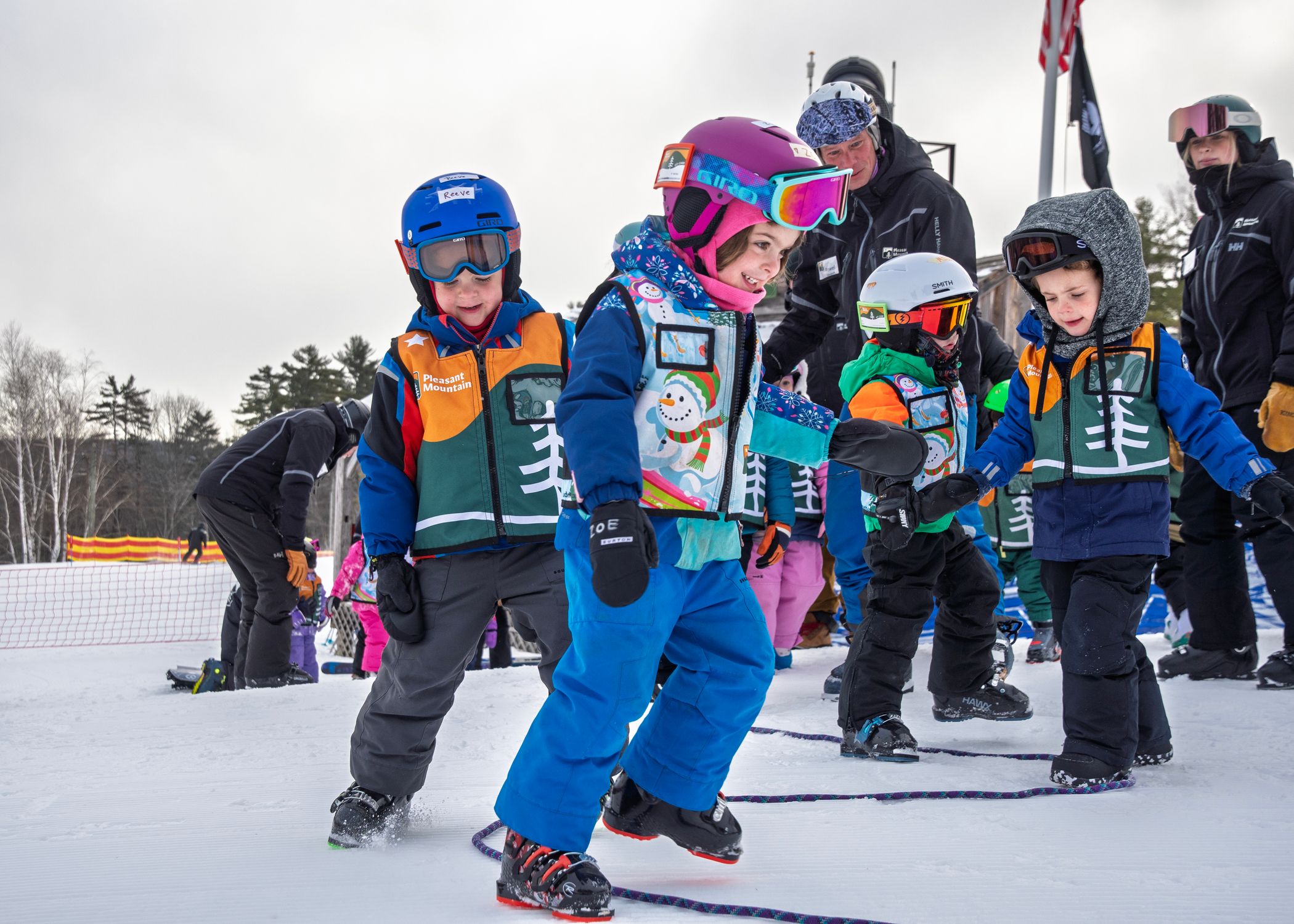 Childrens learning skills without their skis on the snow