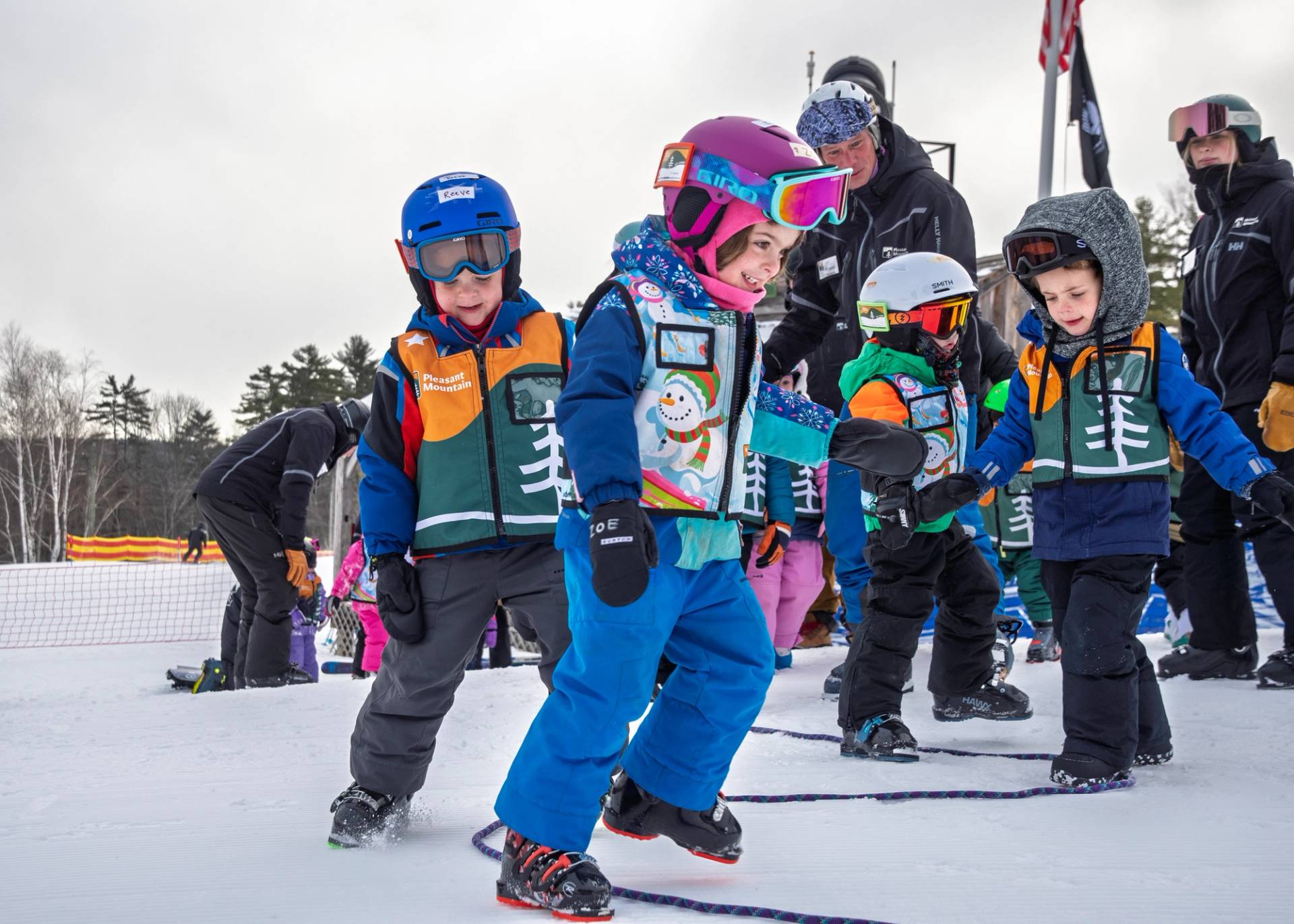 Childrens learning skills without their skis on the snow