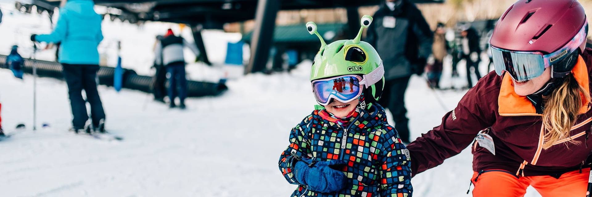 Mother and child skiing to chairlift