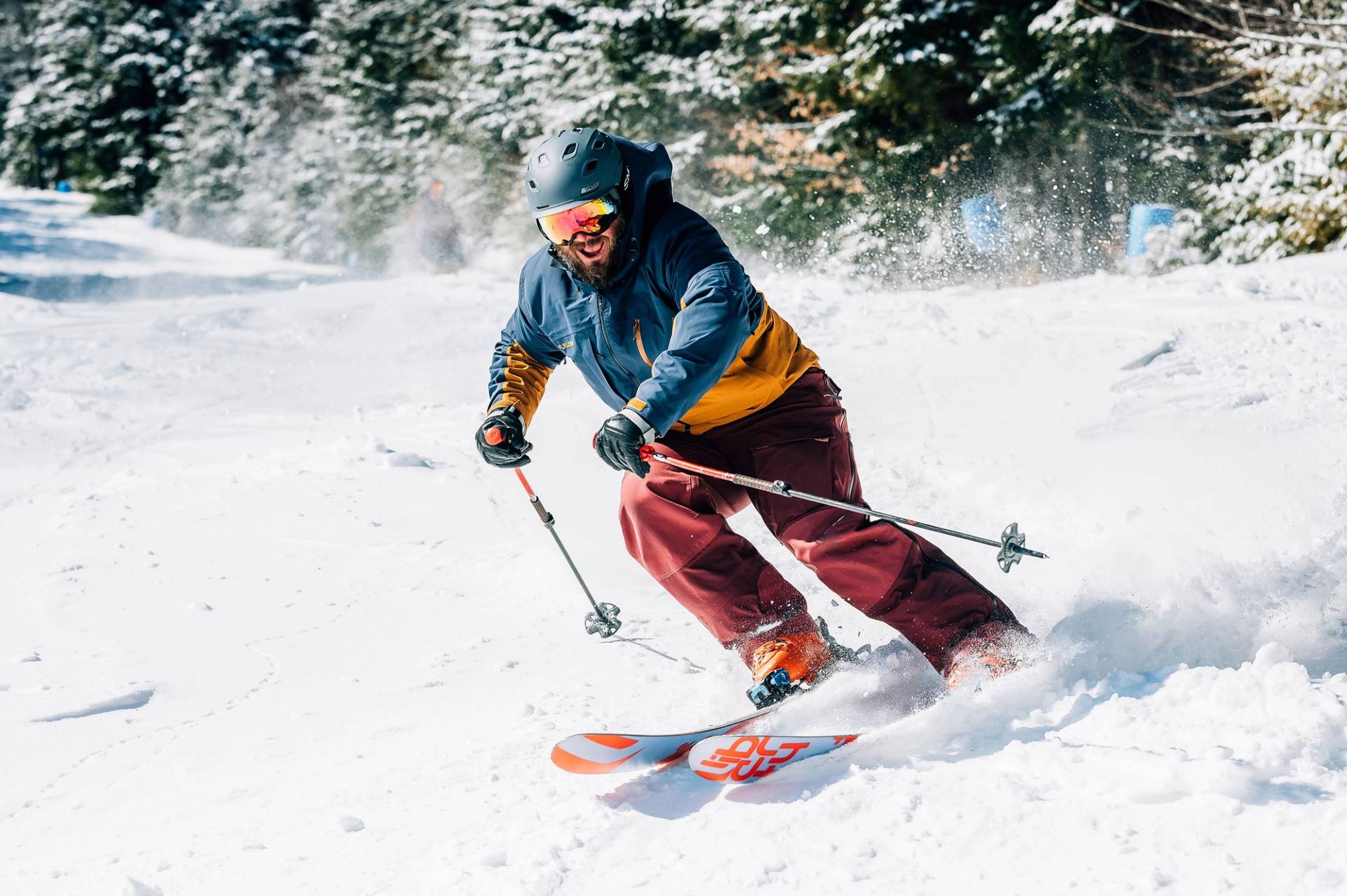 Male smiling and charging through fresh snow