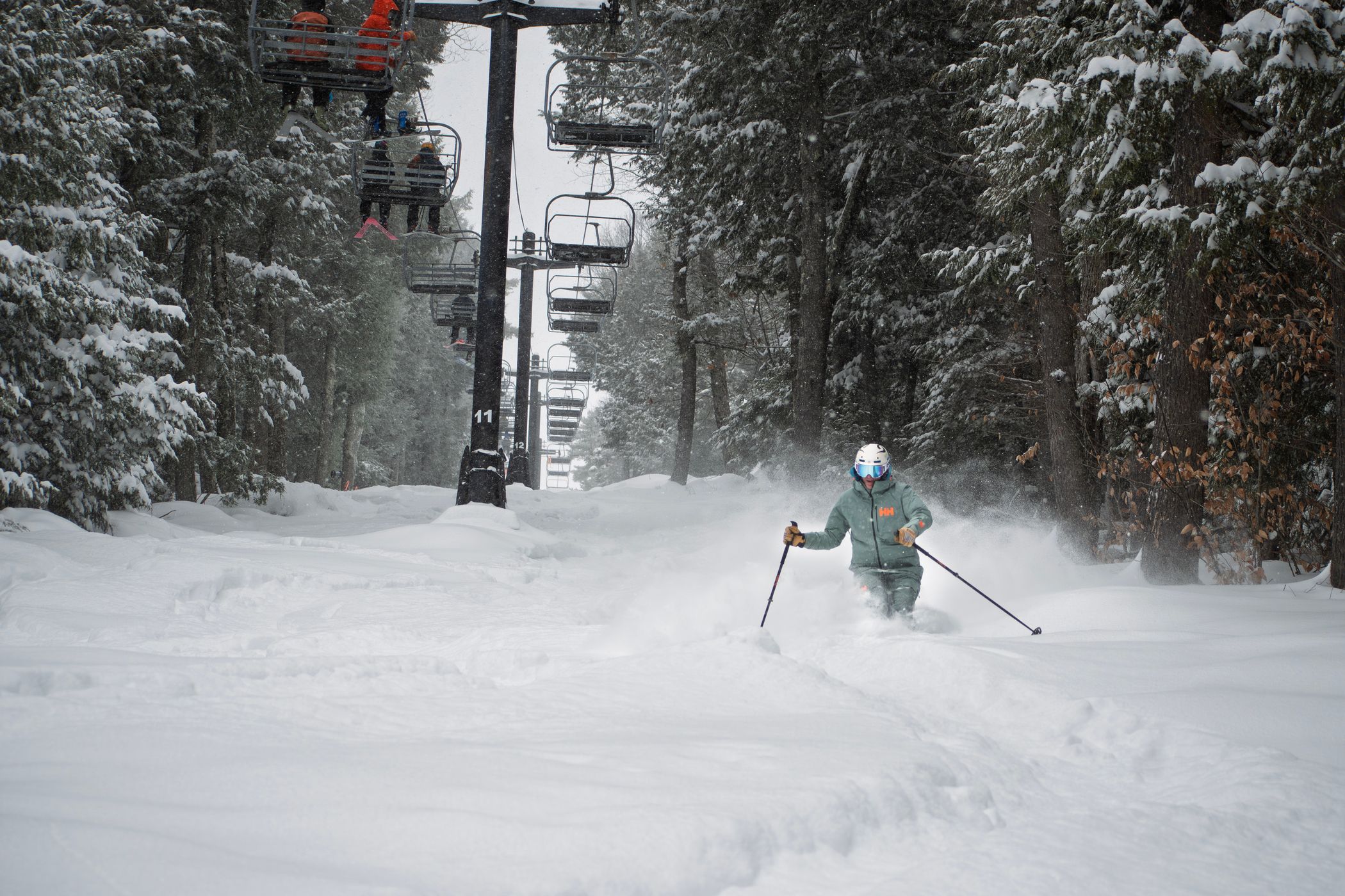 Monochrome skier in poachers with fresh powder