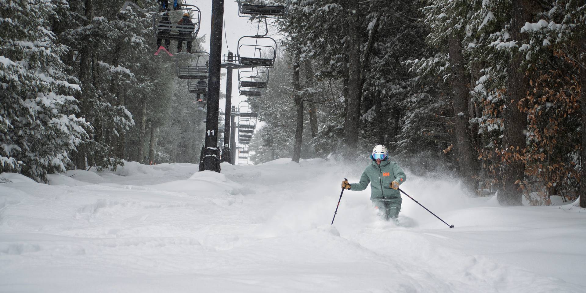 Monochrome skier in poachers with fresh powder