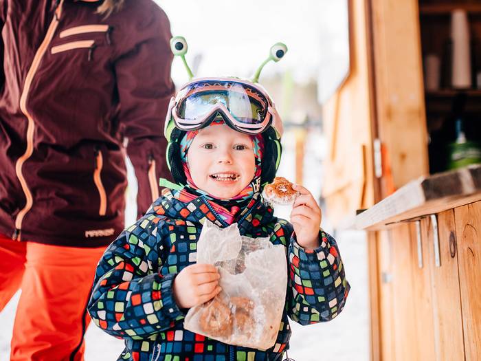 little boy eating donuts