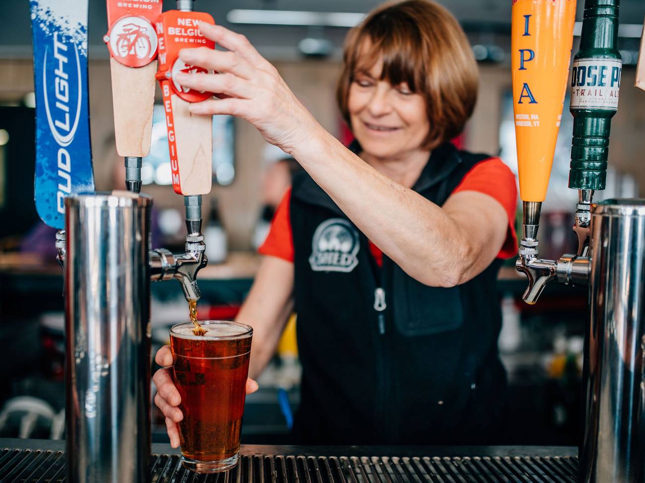 Bartender pours a draft beer in Blizzard's Pub