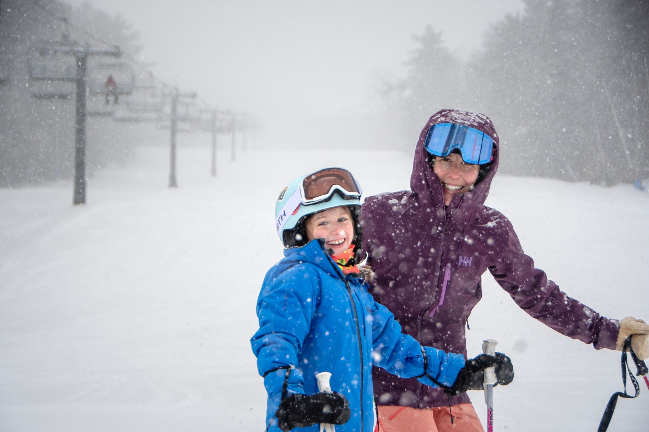 Mum and Daughter standing and smiling in the snow