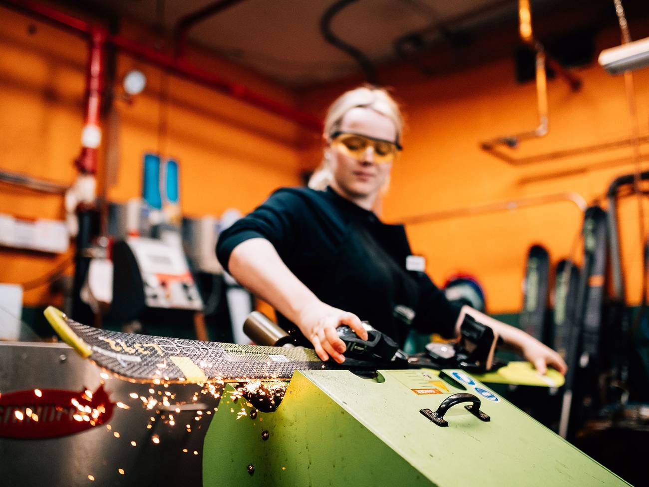 Technician sharpens a ski in the tuning shop