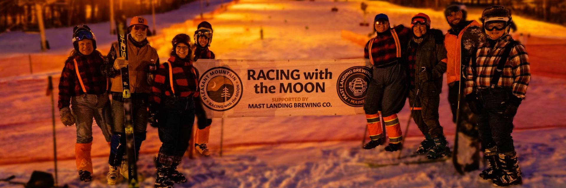 skies walk across snow to chairlift at night