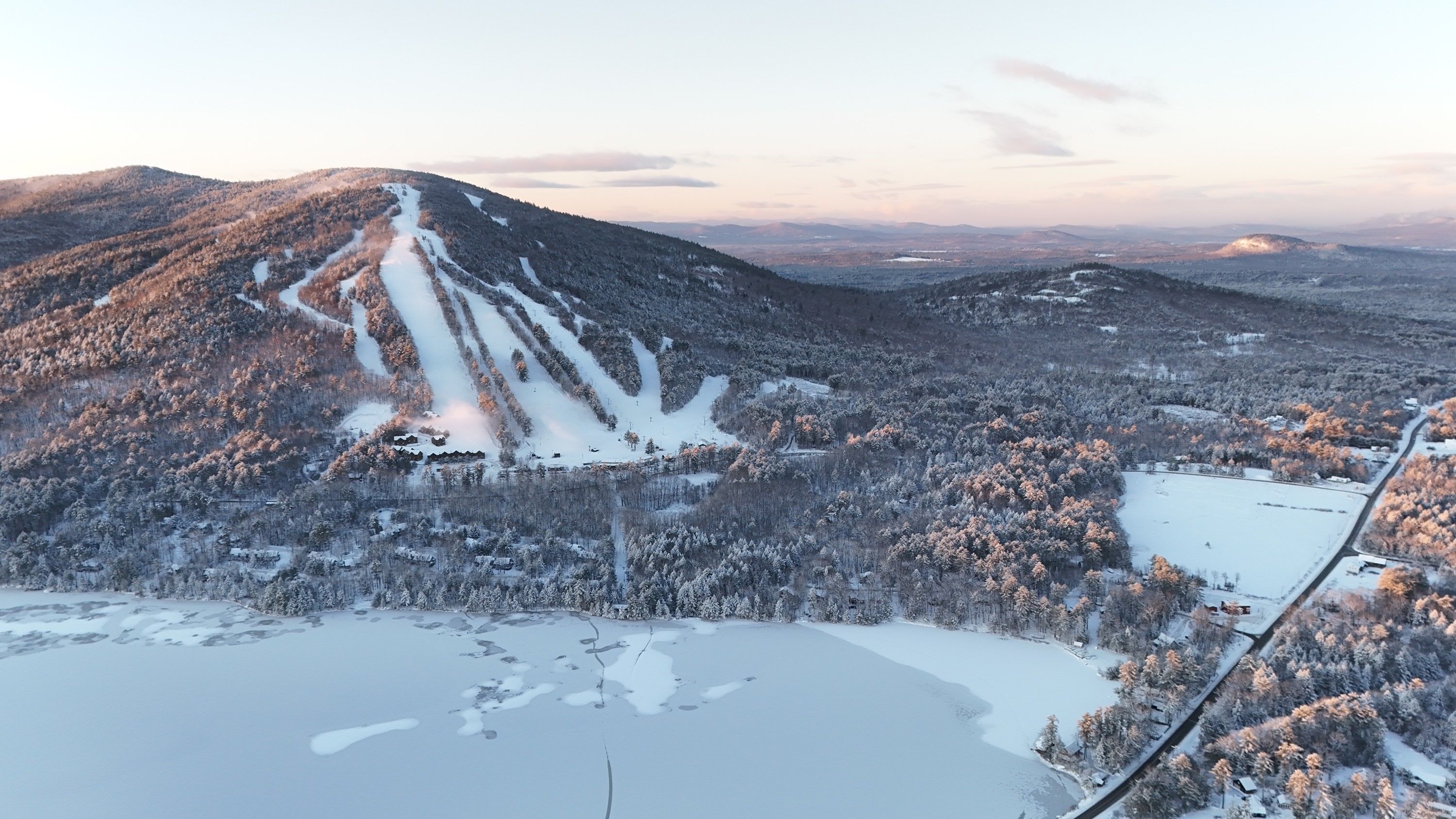 Drone image of Pleasant Mountain covered in snow