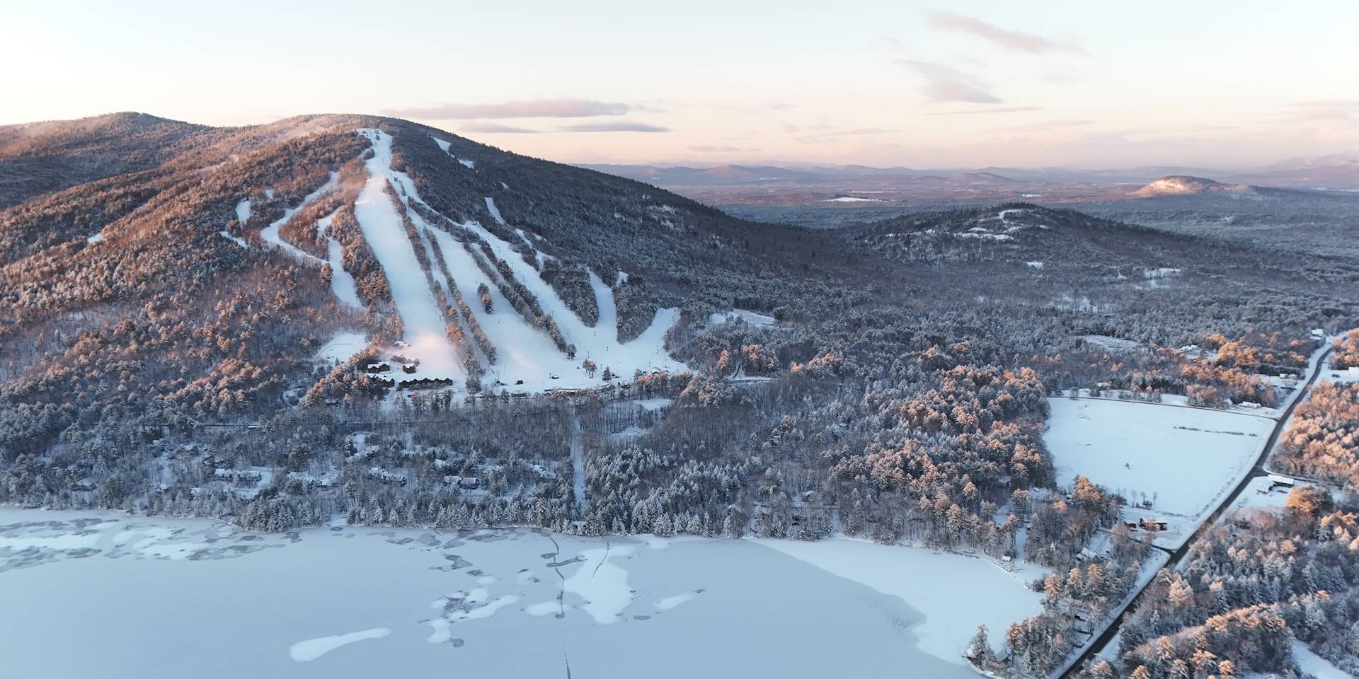 Drone image of Pleasant Mountain covered in snow