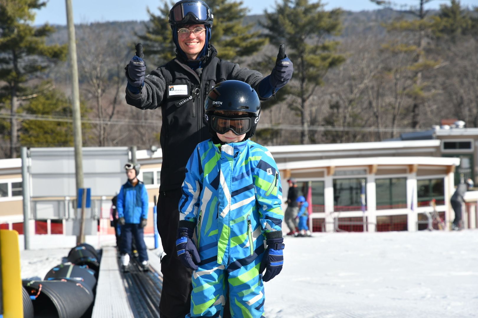 Child and instructor head up the magic carpet