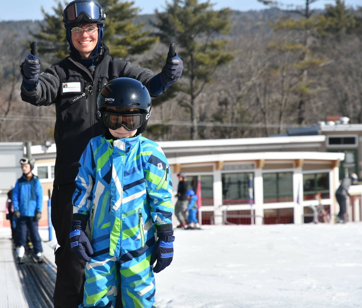 Child and instructor head up the magic carpet