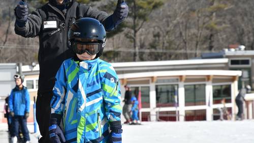 Child and instructor head up the magic carpet