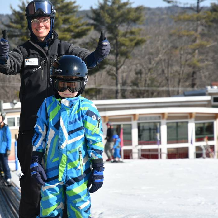 Child and instructor head up the magic carpet