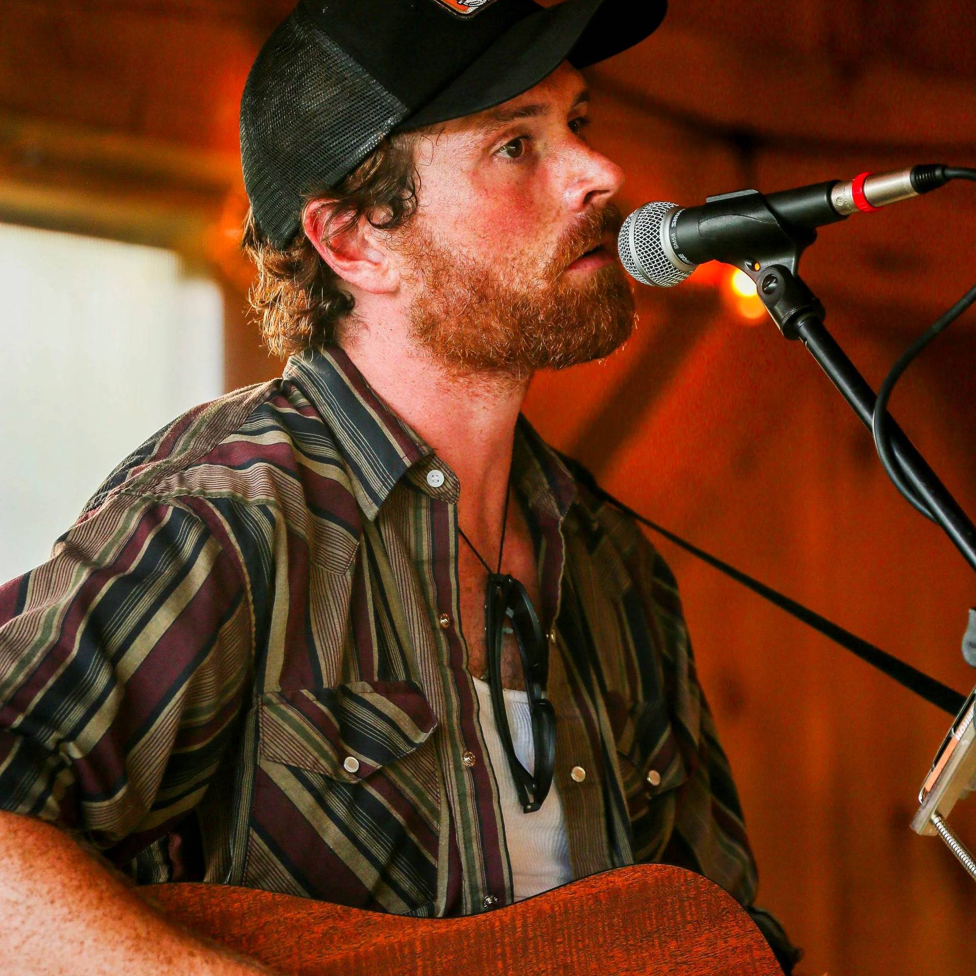 Chase Winn singing with a guitar