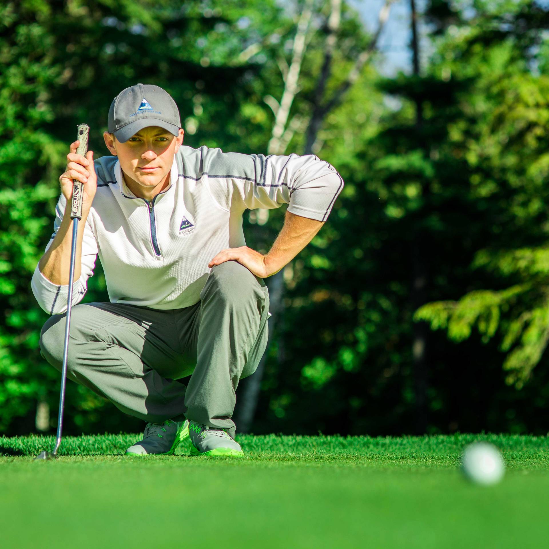 Golfer eyeing ball