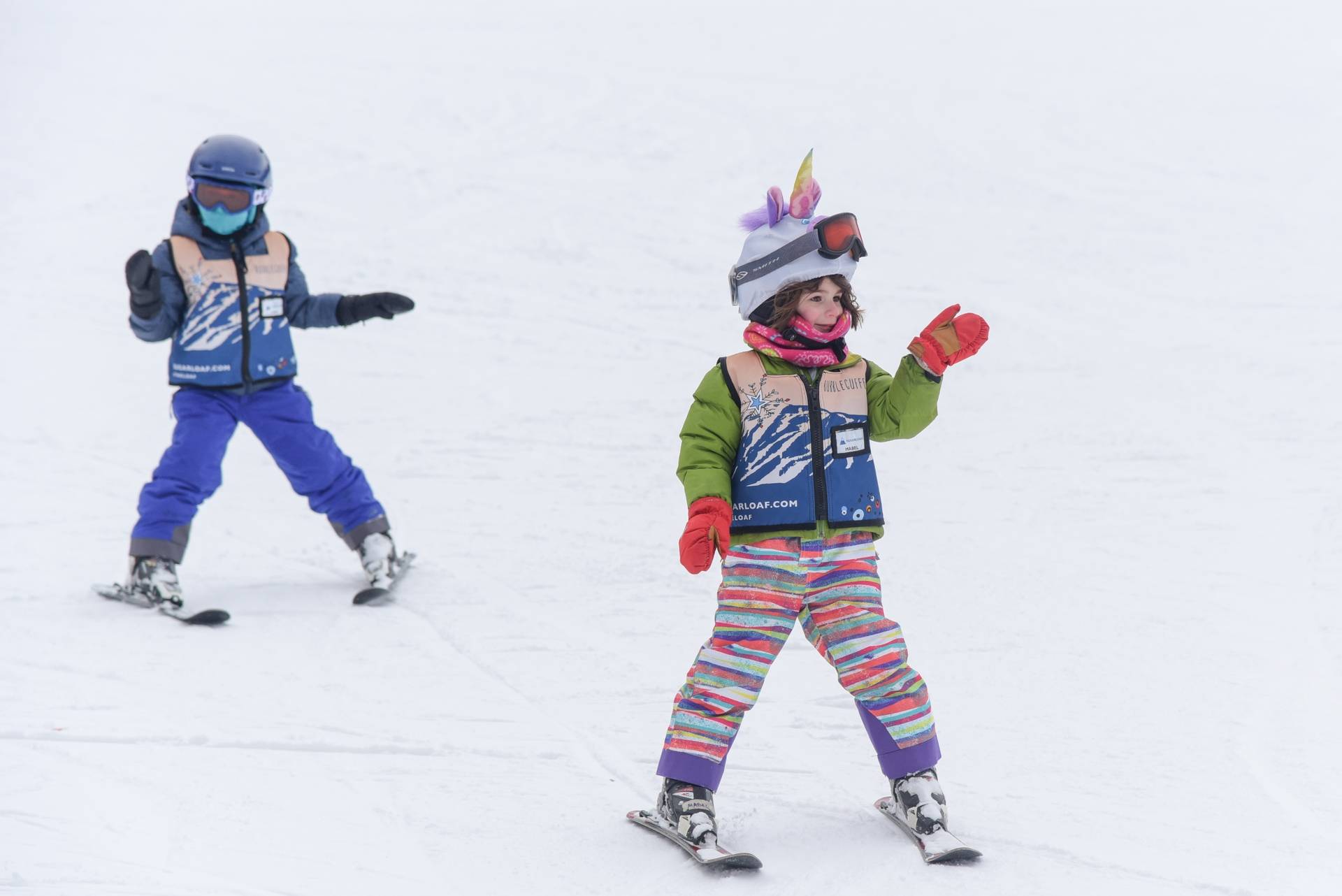 Two children skiing in a lesson