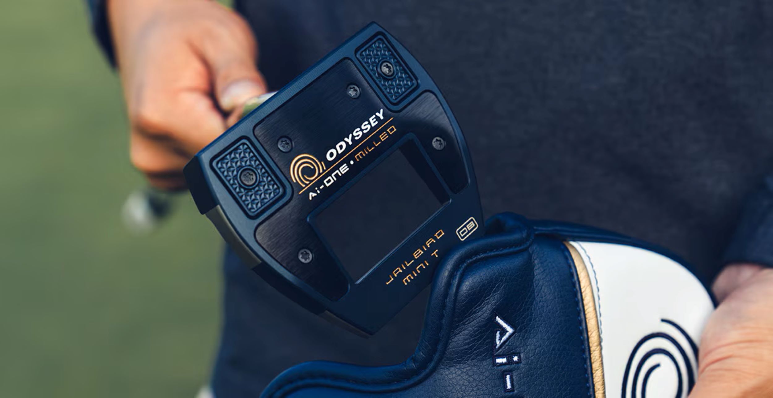 Golfer holding Odyssey clubs